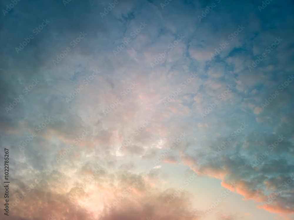 The rays of the sun breaking through the dramatic clouds in the evening or in the morning in the sunset or sunrise sky. The rays of the sun breaking through the dramatic clouds in the evening or in the morning in the sunset or sunrise sky.