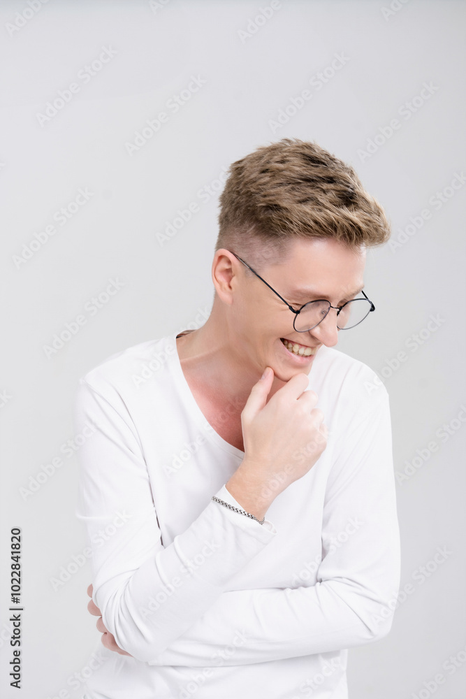 Man with glasses is smiling and looking at the camera. He is wearing a white shirt and has his arms crossed Man with glasses is smiling and looking at the camera. He is wearing a white shirt and has his arms crossed