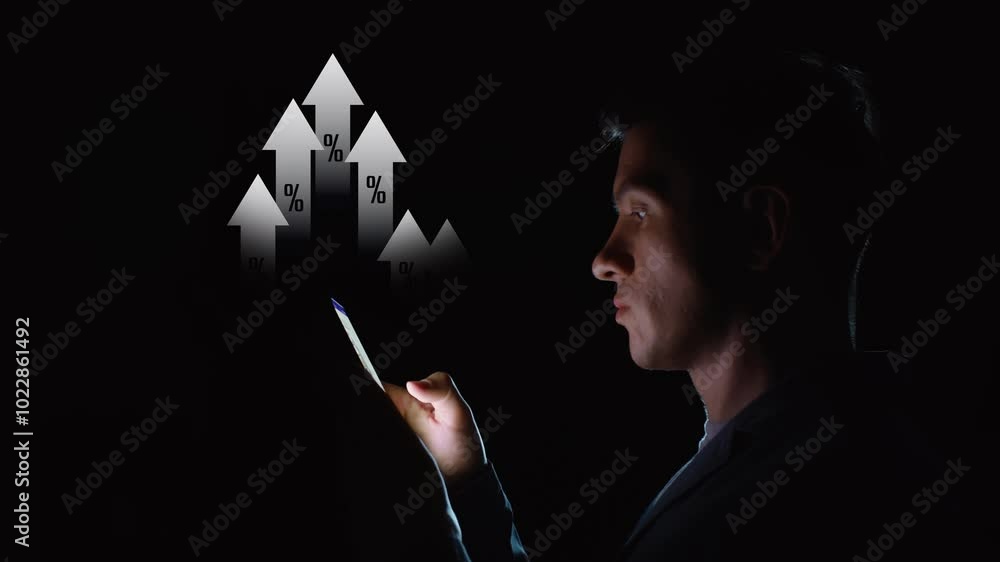 A man is using a smartphone in the dark and digital arrows with percentage symbols growing upward appear above him. Financial success concept. Cg