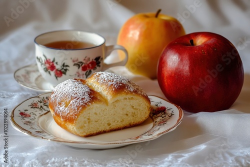 Colazione, con brioche su piatto bianco, tazza di thÃ©, ed una mela - generative ai photo