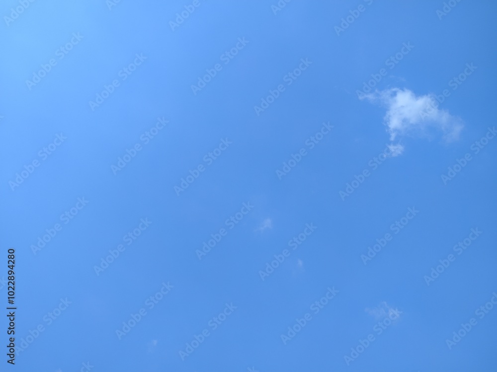 A serene blue sky with wispy white clouds drifting lazily, creating a peaceful and calming atmosphere. Perfect for nature-themed projects. A serene blue sky with wispy white clouds drifting lazily, creating a peaceful and calming atmosphere. Perfect for nature-themed projects.