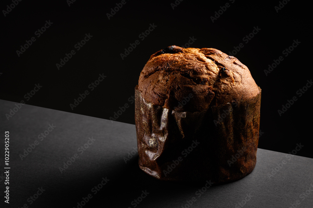 Christmas panettone on a dark background with dramatic lighting copy space