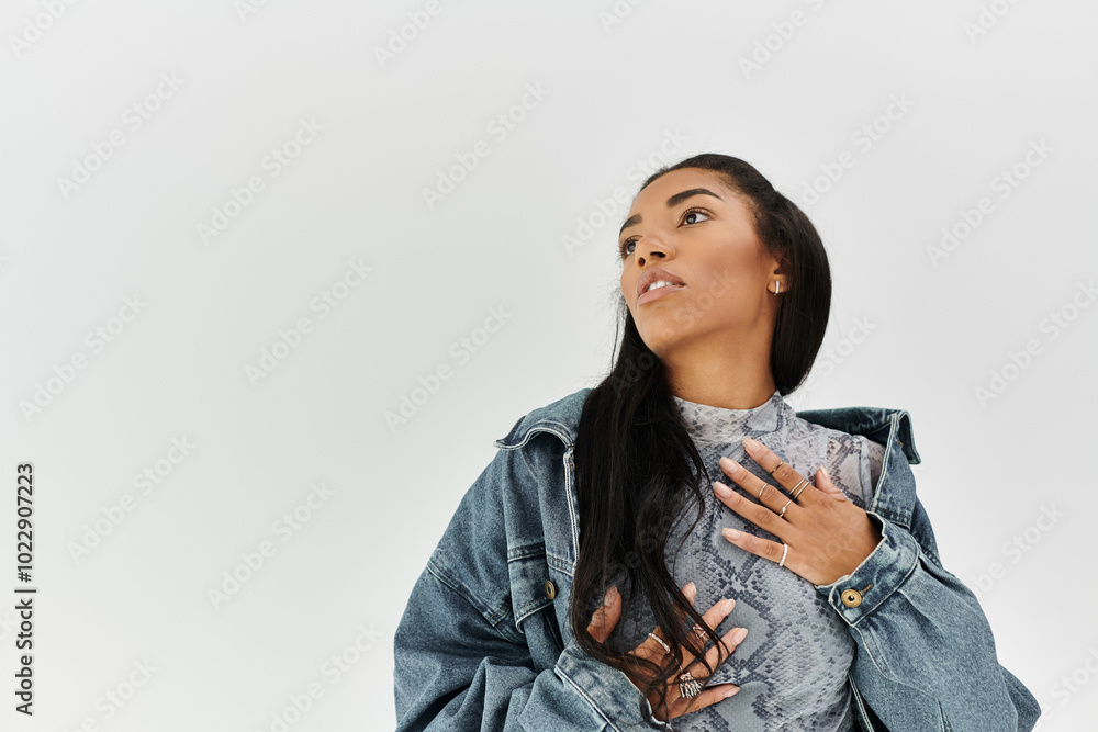 A stylish young woman showcases her trendy outfit while reflecting self assurance indoors. A stylish young woman showcases her trendy outfit while reflecting self assurance indoors.