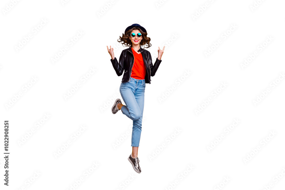 Full length photo of cheerful girl with curly hairstyle jump show horned sign rock on pank concert wear denim jeans good look isolated over yellow color background Full length photo of cheerful girl with curly hairstyle jump show horned sign rock on pank concert wear denim jeans good look isolated over yellow color background