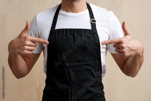 Person in white t-shirt and apron giving a thumbs up, highlighting apron.