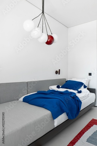 A Beautiful Modern Bedroom Featuring Stylish Lighting and Cozy Decor for Relaxation