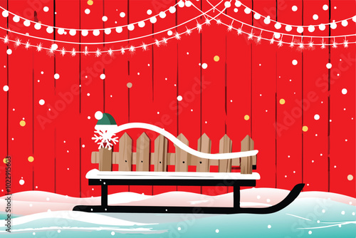 A rustic wooden sled with a green hat and a snowflake sits against a red barn with white snow.