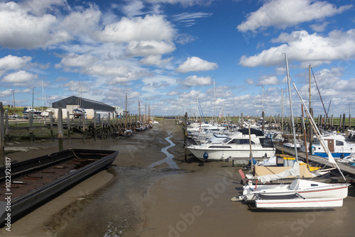 The yacht harbour at Paal in Graauw, Zeeland in the Netherlands. Low tide with boats on a summers day. photo