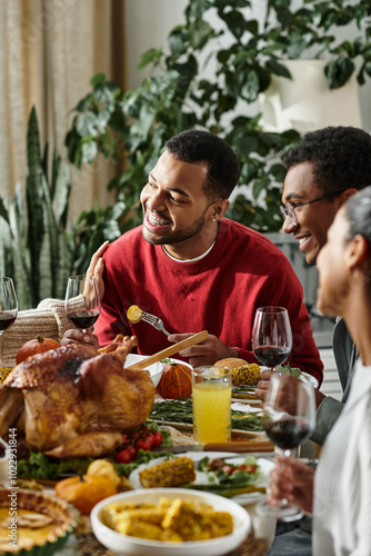 A group of friends joyfully shares a Thanksgiving meal filled with laughter, food, and warmth.