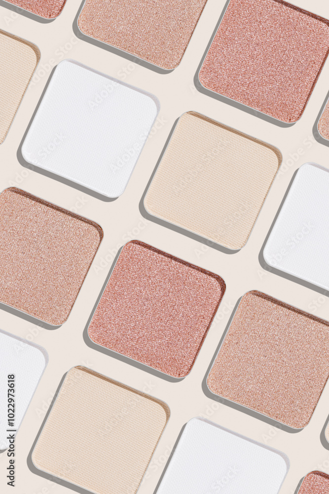 Fototapeta premium Neutral Eyeshadow palette background, mix of matte, shimmer shades white pink beige hues. Aesthetic top view pattern for beauty, makeup, cosmetics themes, Neutral colored swatches eyeshade refills