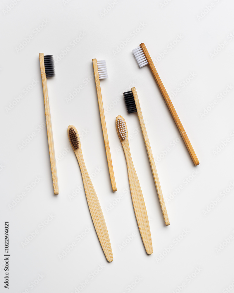 Top view of eco-friendly bamboo toothbrushes arranged on grey white background, emphasizing sustainability and minimalism, Natural organic bathroom beauty product concept, dental .hygiene, flat lay Top view of eco-friendly bamboo toothbrushes arranged on grey white background, emphasizing sustainability and minimalism, Natural organic bathroom beauty product concept, dental .hygiene, flat lay