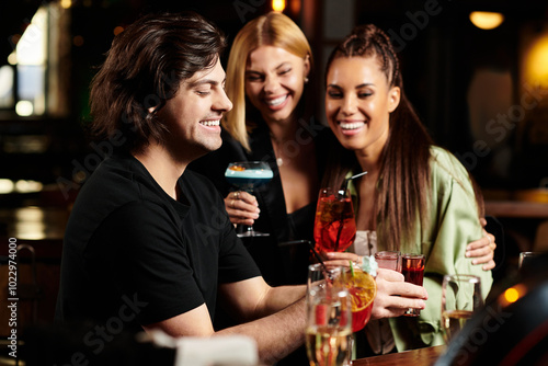 Colleagues share laughter and drinks, celebrating their teamwork in a lively bar atmosphere. photo