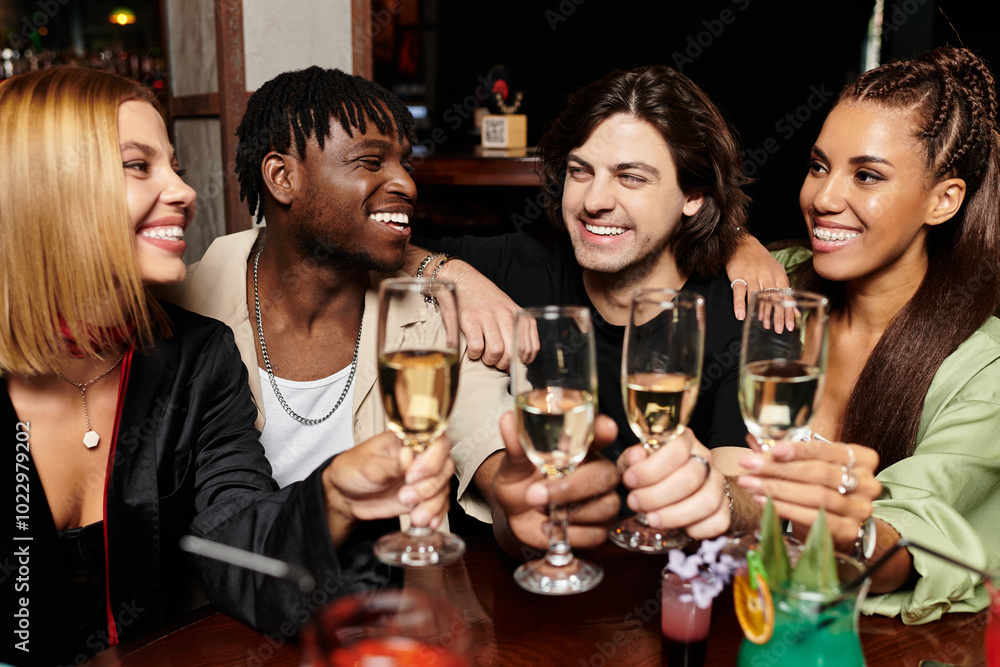 A lively group of young professionals toasting with glasses in a vibrant corporate celebration. A lively group of young professionals toasting with glasses in a vibrant corporate celebration.