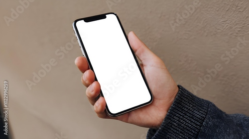 Close-Up Hand Holding Phone Mockup: Blank Screen Smartphone Ready for App Showcase and Digital Marketing in a Casual Setting photo