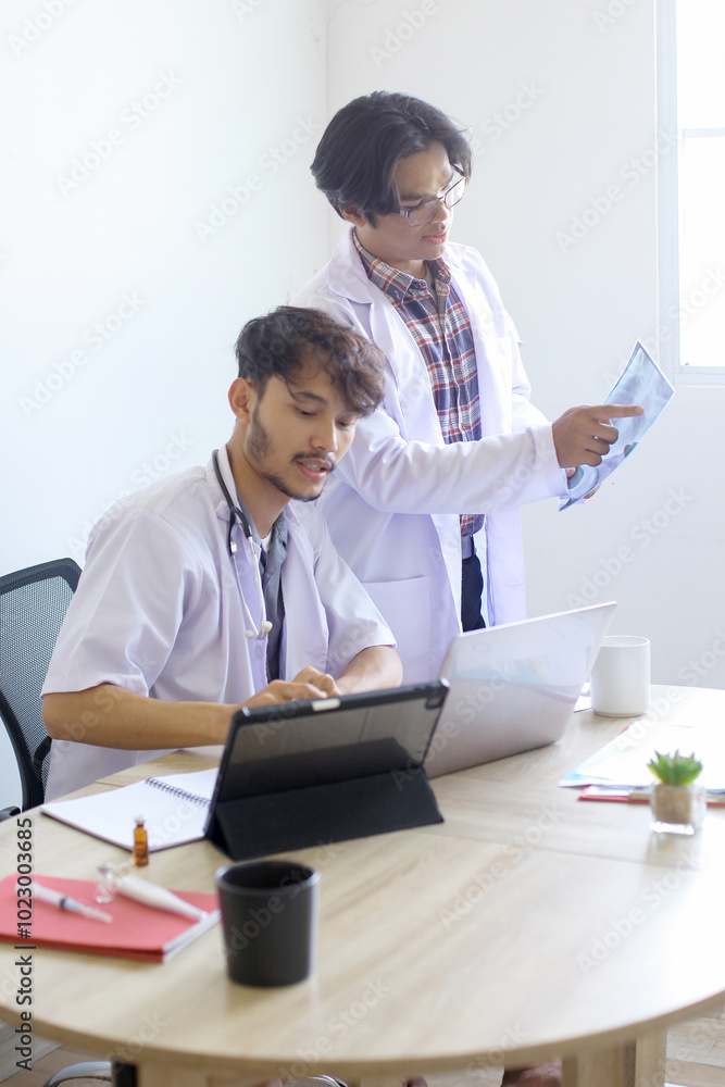 Two Young Man Doctors Discussing X Ray Report Data Together At Hospital. Two Young Man Doctors Discussing X Ray Report Data Together At Hospital.
