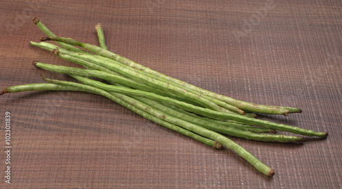 French beans with stewed green peas on wooden background. Healthy food concept.