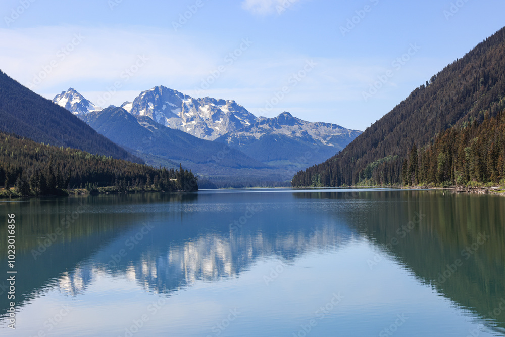 mountains are reflected in the smooth surface of duffey lake, british columbia mountains are reflected in the smooth surface of duffey lake, british columbia