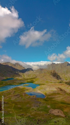 Moving clouds and shadows over the lakes on the top of mountains. Nature timelapse vertical video. photo