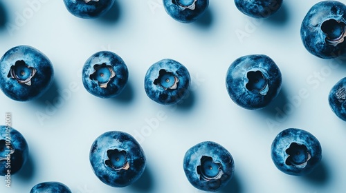 A close-up of fresh blueberries resting on a pristine white background, showcasing their rich blue color and natural sheen