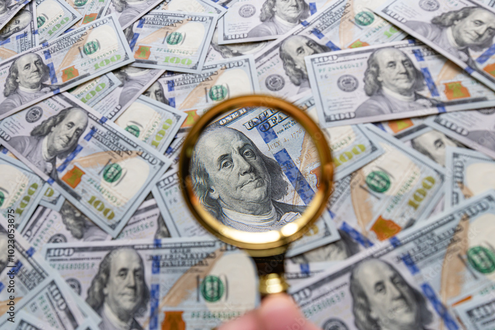 100 dollar banknote and magnifying glass 100 dollar banknote and magnifying glass