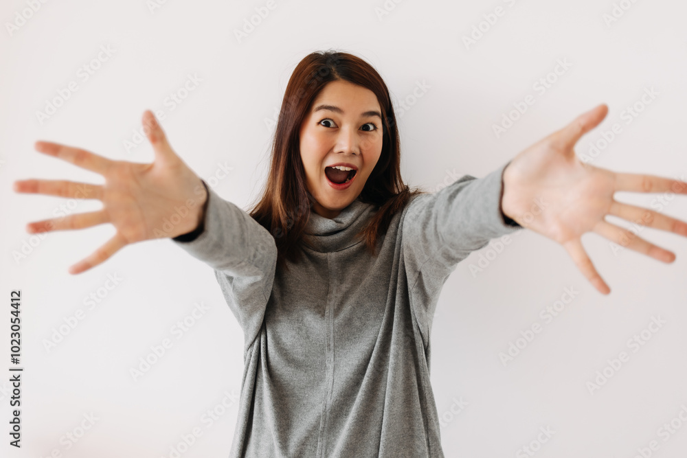 Happy asian Thai woman feeling yeah, hand raising up and spread out, good thing happen, successful isolated over white background wall. Happy asian Thai woman feeling yeah, hand raising up and spread out, good thing happen, successful isolated over white background wall.