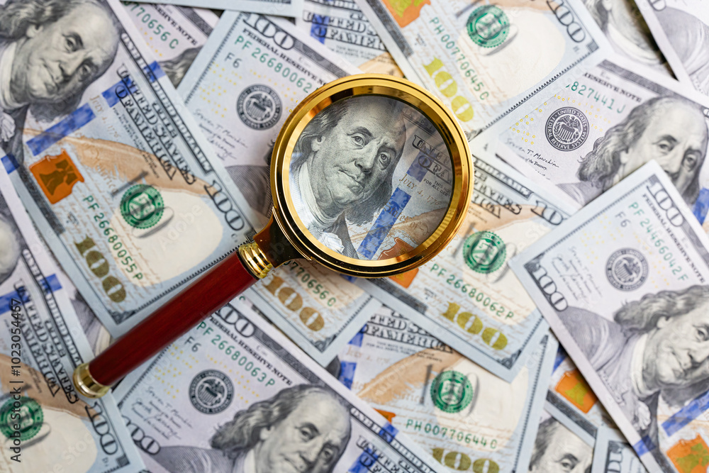 100 dollar banknote and magnifying glass 100 dollar banknote and magnifying glass