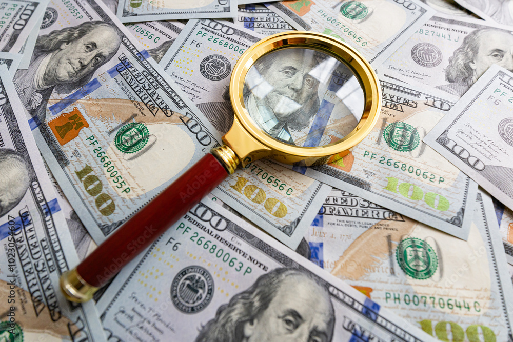 100 dollar banknote and magnifying glass 100 dollar banknote and magnifying glass