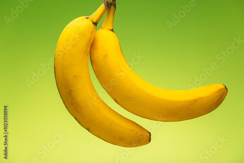 Ripe yellow bananas on green background, healthy nutrition full of vitamins for a healthy lifestyle.  photo