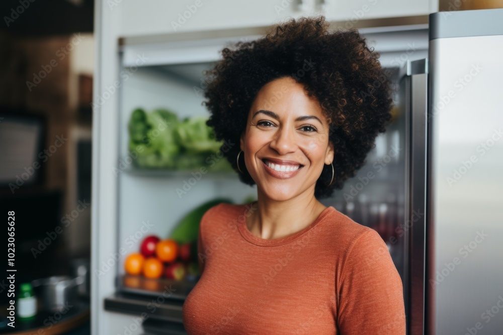 Portrait of a African American middle aged fit woman standing in healthy kitchen Portrait of a African American middle aged fit woman standing in healthy kitchen