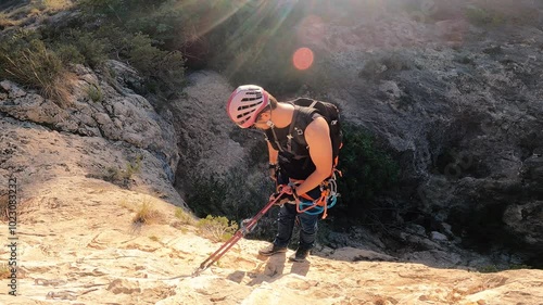 Man rock climbing aerial view of sportsman rapelling mountain in La Panocha, el Valle Murcia, Spain woman rapel down a mountain climbing a big rock photo