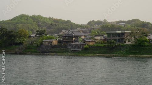 Uji river bank with houses and trees photo