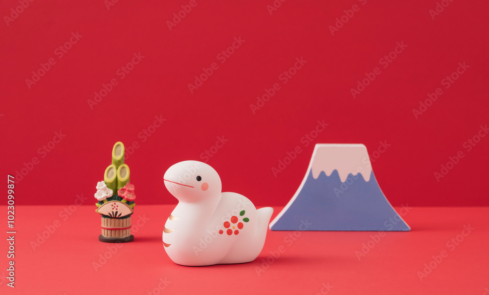 Japanese new year. Zodiac Snake. Snake ornament and Mt.Fuji, and kadomatsu on the red background. 日本のお正月。干支の巳(ヘビ)。赤背景上の巳の置物と富士山と門松。 Japanese new year. Zodiac Snake. Snake ornament and Mt.Fuji, and kadomatsu on the red background. 日本のお正月。干支の巳(ヘビ)。赤背景上の巳の置物と富士山と門松。