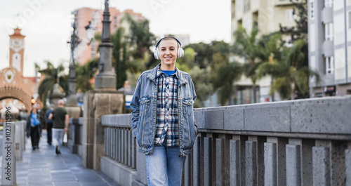 Photography Young bald woman listening music playlist with city in background - City lifesty