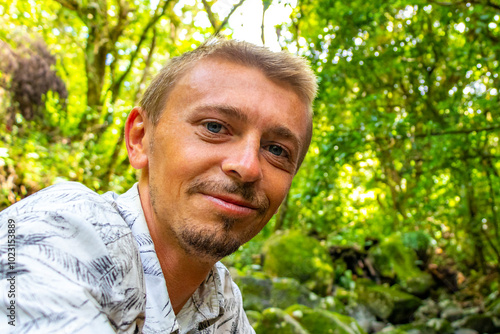 Handsome man tourist with tropical forest jungle landscape Costa Rica. photo