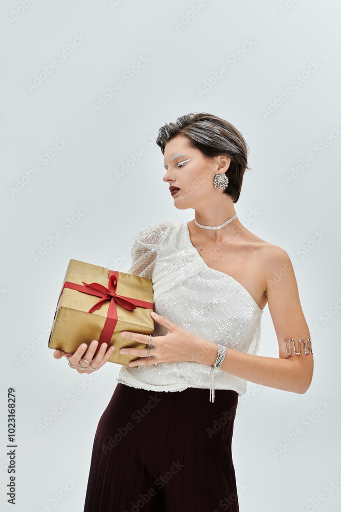 A graceful woman dressed in cozy winter elegance gently cradles a gift while gazing thoughtfully. A graceful woman dressed in cozy winter elegance gently cradles a gift while gazing thoughtfully.