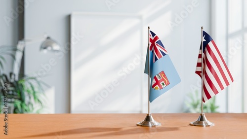 FLAGS OF FIJI AND LIBERIA ON TABLE photo