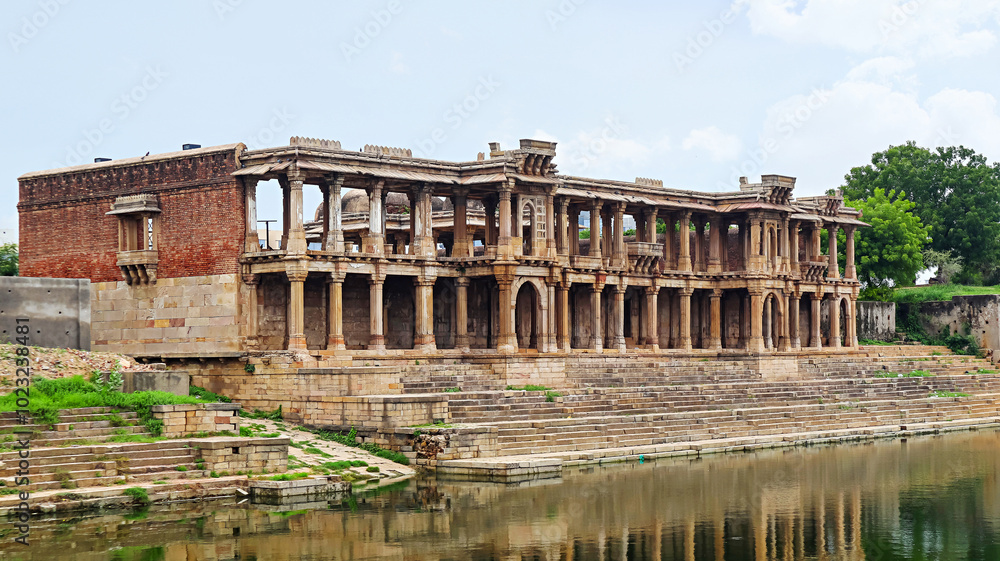 Fototapeta premium View of the ruined Queen's Palace beside Sarkhej Pond, Sarkhej Roza, Ahmedabad, Gujarat, India.