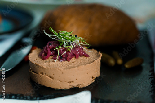 Gourmet Chicken Liver Pate with Pickled Red Onions and Fresh Microgreens on a Rustic Slate Platter photo