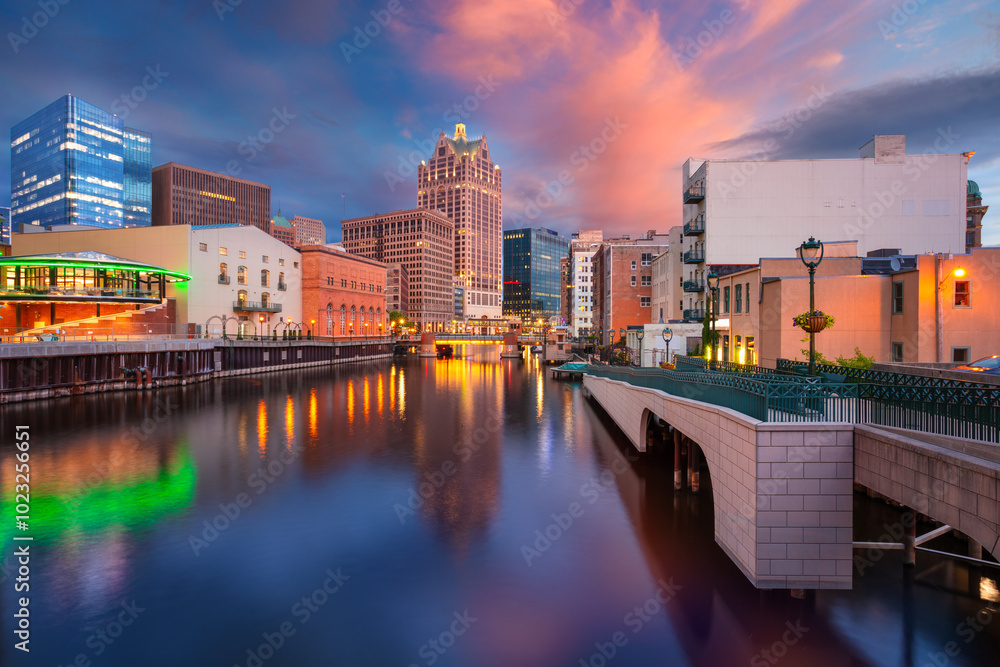 Milwaukee, Wisconsin, USA. Cityscape image of downtown Milwaukee, Wisconsin, USA with reflection of the skyline in Milwaukee River at summer sunset.