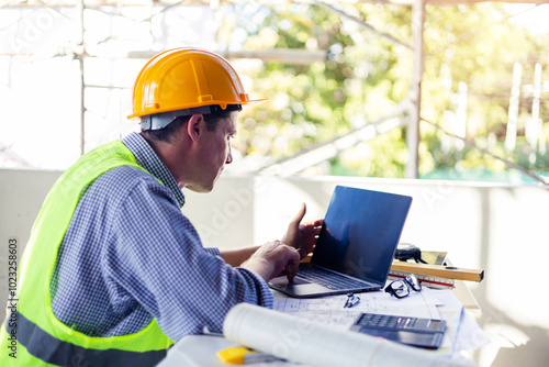Caucasian Male architect engineer construction worker using computer laptop working on blueprint design plan using pencil tool analyzing design innovation building landscape housing architecture.
