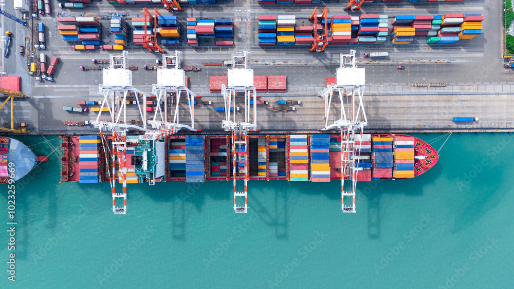 crane loading cargo container from truck to container ship in the ...