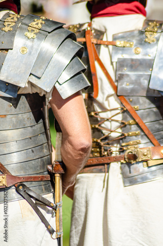 Roman legionaries in metal armor called lorica segmentata at a historical reenactment party in Roman times