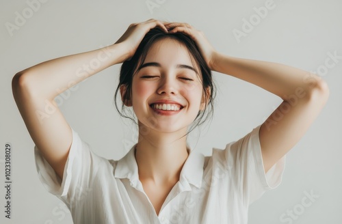 Portrait of a Smiling Young Woman in a White Shirt