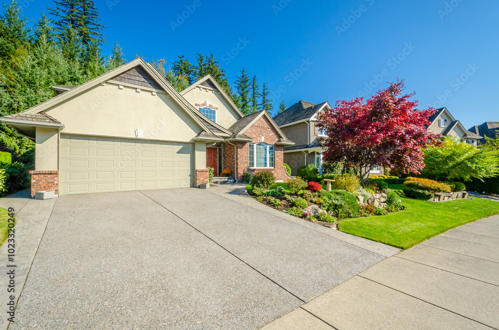 Garage door in luxury house with trees and nice landscape in Vancouver, Canada Garage door in luxury house with trees and nice landscape in Vancouver, Canada