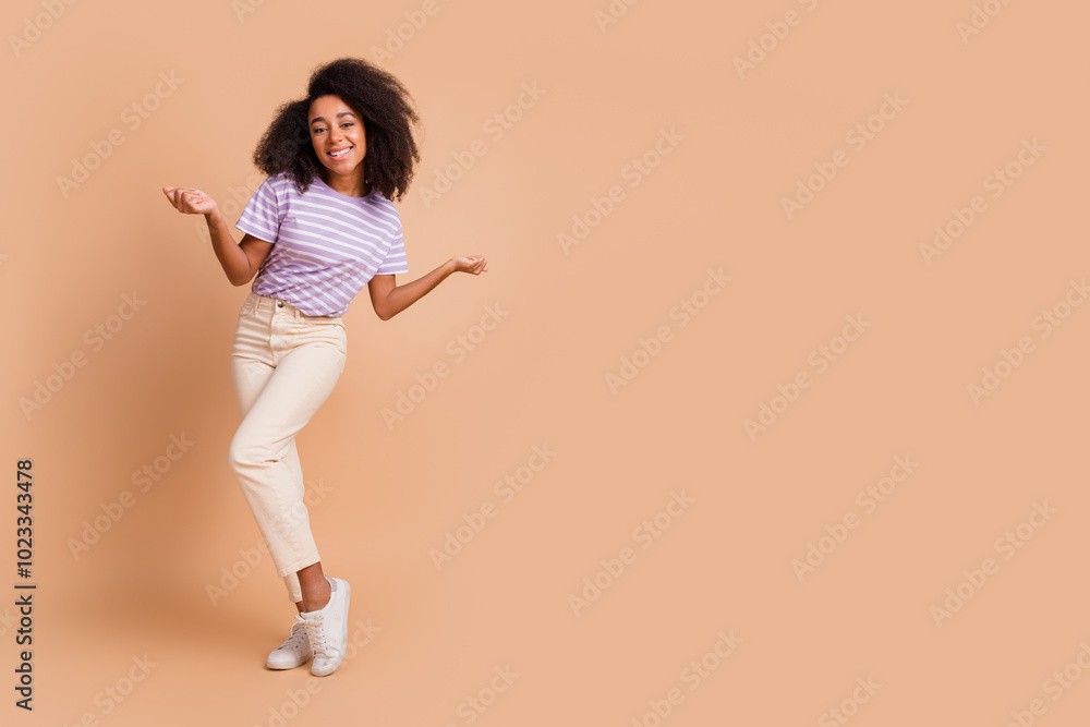 Full body portrait of pretty young girl dancing chilling wear t-shirt isolated on beige color background Full body portrait of pretty young girl dancing chilling wear t-shirt isolated on beige color background