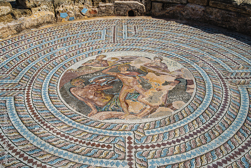 Mosaic image of the duel between Theseus and the Minotaur. House of Theseus. Paphos Archaeological Park. Cyprus. Inscription: Theseus, Minotaur, Labyrinth, Ariadne, Crete. photo