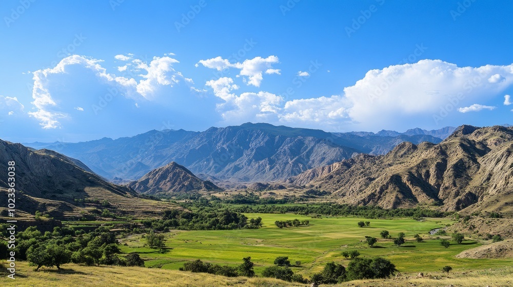 Obraz premium Scenic mountain range with clear skies and lush green valley. Ideal for outdoor adventures, nature tourism, and environmental conservation.