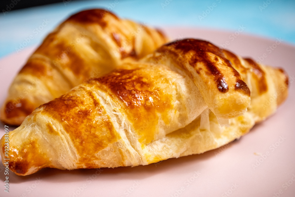 croissant on a pink plate croissant on a pink plate