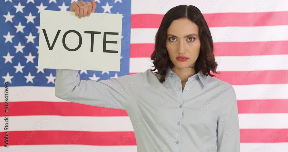 Woman politician holds Vote sign against American flag. Serious female emphasizes significance of voting and civic engagement in election Woman politician holds Vote sign against American flag. Serious female emphasizes significance of voting and civic engagement in election