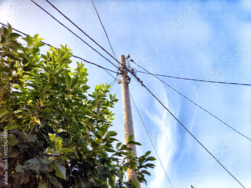 Old pole with wires against the sky. Electric transmission line. Eco-friendly energy photo